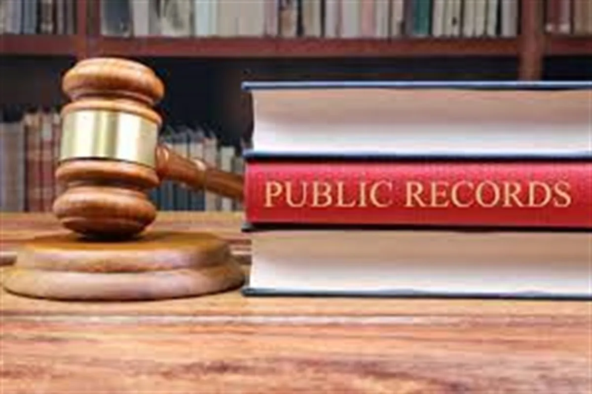Gavel beside law books with a Public Records spine, illustrating Andrew Hillman's public record