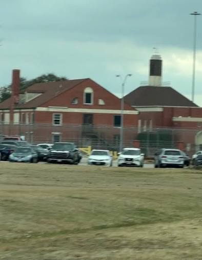 Seagoville Federal Detention Center exterior with brick administrative building and perimeter fencing
