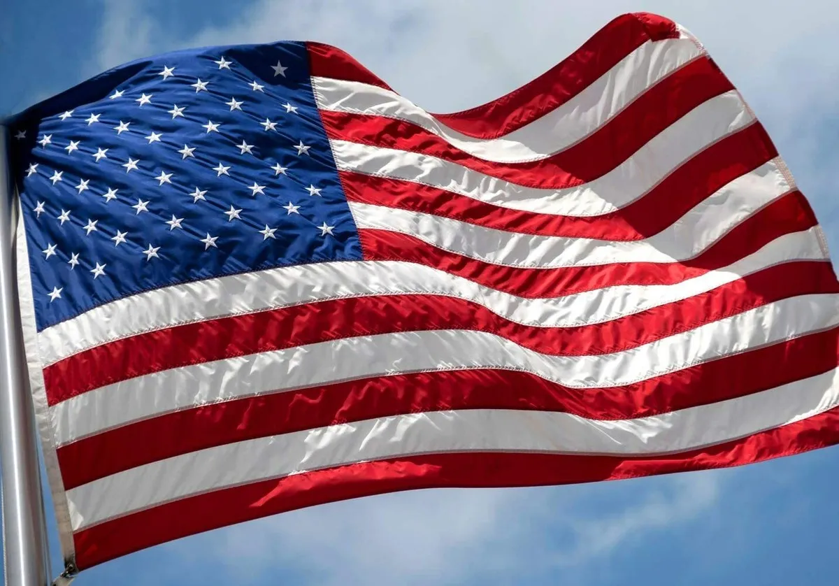 Close-up of an American flag waving under clouds on Andrew Hillman's record