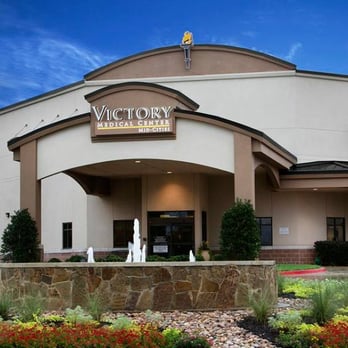 Victory Medical Center Mid Cities exterior with stone water feature